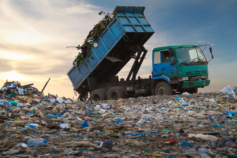 Dump,Truck,Unloading,Waste,On,A,Landfill