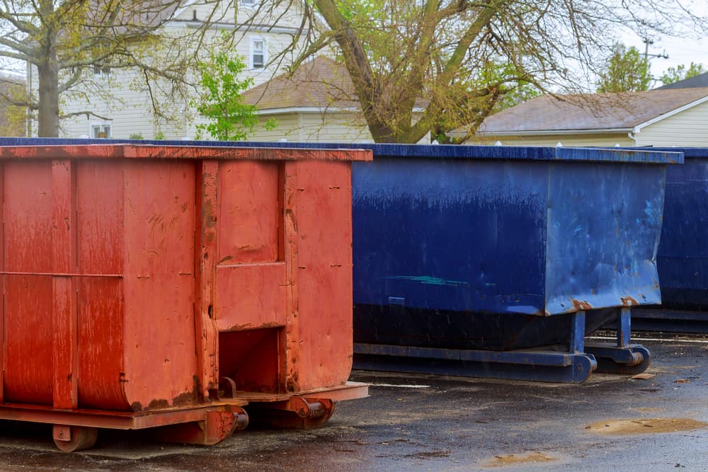 dumpsters outside in parking lot.